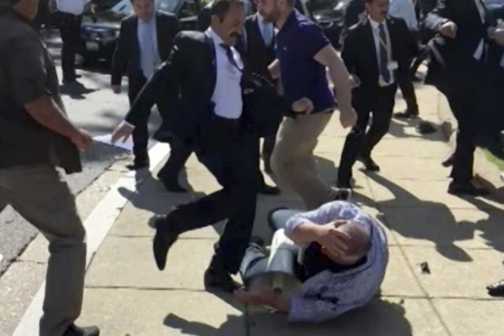 In this frame grab from video provided by Voice of America, members of Turkish President Recep Tayyip Erdogan’s security detail are shown violently reacting to peaceful protesters during Erdogan's trip last month to Washington. House Republican and Democratic lawmakers are expected to approve overwhelmingly a resolution that calls for members of Erdogan’s security detail who were involved in the incident to be brought to justice. Photo: Voice of America via AP