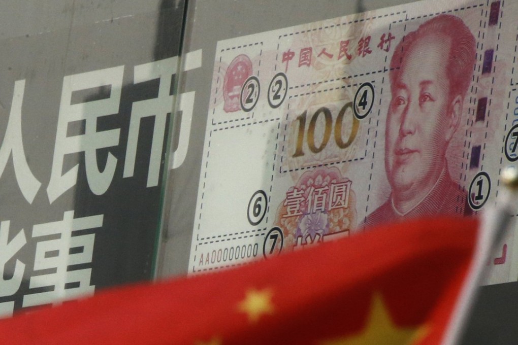 China's national flag is seen in front of a poster explaining the design of new 100 yuan banknote at a branch of a commercial bank at a business district in Beijing. Photo: Reuters