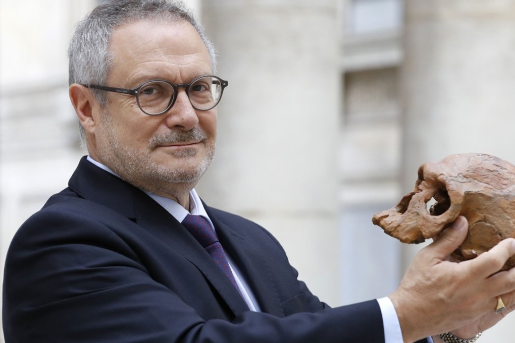 French paleoanthropologist Jean-Jacques Hublin poses with the casting of a skull of Homo Sapiens discovered in Morocco on June 6, 2017 in Paris. Our human species already roamed Africa 300,000 years ago, sporting modern-looking faces that would not stand out in a crowd today, according to research published on June 7, 2017 that advanced Homo sapiens' origins by a hundred millennia. Photo: AFP