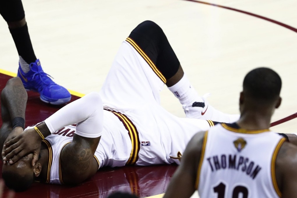 Cleveland Cavaliers forward LeBron James (centre) falls to the ground after colliding with a teammate. Photo: EPA