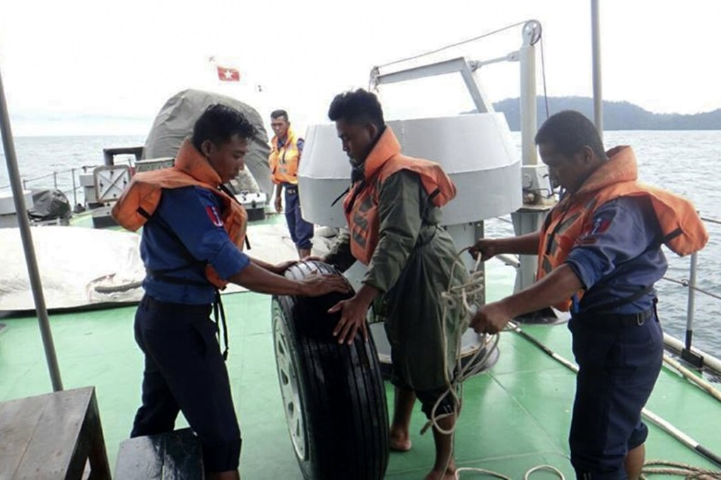 Sailors recover the wheel of the military transport plane from Andaman Sea. Photo: EPA