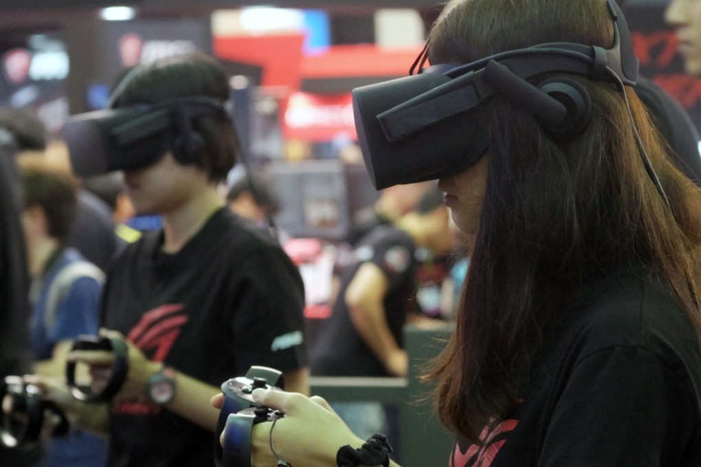Visitors test virtual reality VR headsets during the Computex Show in Taipei last month. More then 16.000 companies took part in the even. Photo: AFP