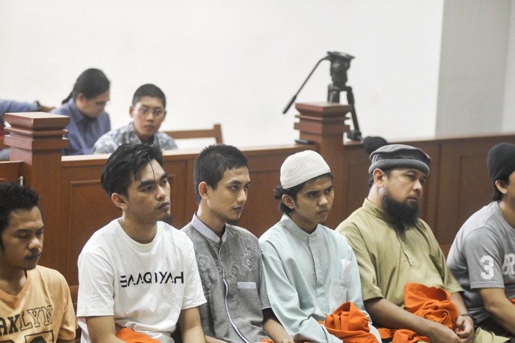 From L-R: Detained Indonesian militants Leonard Hutajulu, Hadi Gusti Yanda, Gigih Rahmat Dewa, Tarmiji, Trio Syafrido, and Eka Saputra attend a hearing at the East Jakarta court in Jakarta. Photo: AFP
