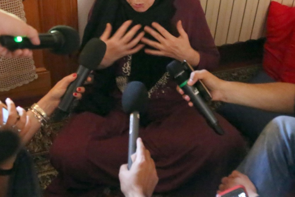 Journalists interview Valeria Collina, the Italian mother of one of the London Bridge attackers, Youssef Zaghba, in her home in Bologna, Italy, on Wednesday. Photo: AP
