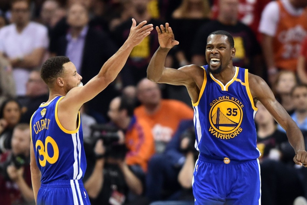 Golden State Warriors guard Stephen Curry and forward Kevin Durant celebrate during the fourth quarter against the Cleveland Cavaliers in game three of the 2017 NBA Finals. Photo: USA Today