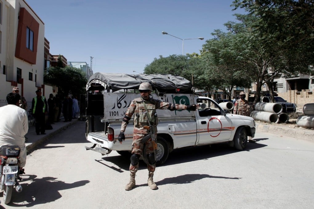A soldier stands guard near the site where two Chinese-language teachers were kidnapped by gunmen in Quetta, Pakistan. Photo: Reuters