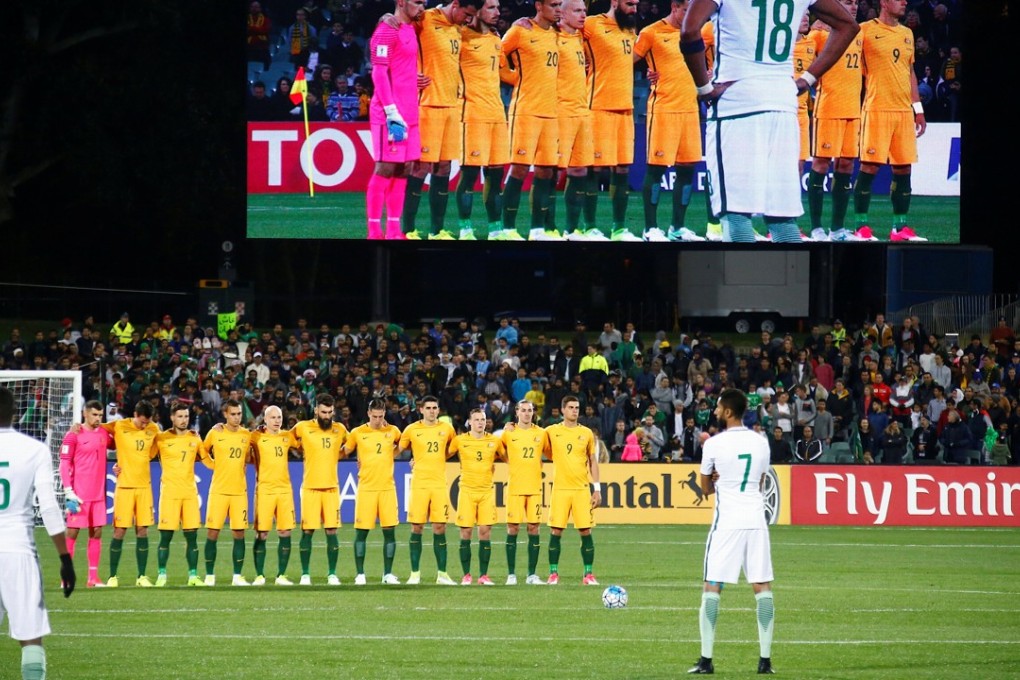 The Australian national team stand together as they observe a minute’s silence as the Saudi Arabia players mill around during the tribute. Photo: Reuters