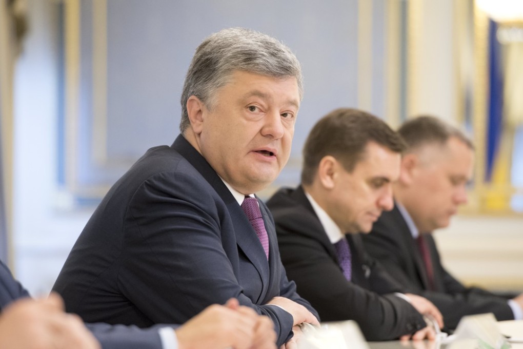 Ukrainian President Petro Poroshenko, (2-L), speaks in Kiev, Ukraine. The country’s parliament said the major foreign policy goal of the country is to become a member of Nato, a move sure to anger powerful neighbour Russia. Photo: EPA