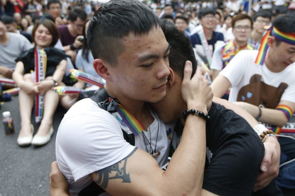 Supporters of lesbian, gay, bisexual and transgender rights greet the court ruling outside the parliament building in Taipei. Photo: EPA