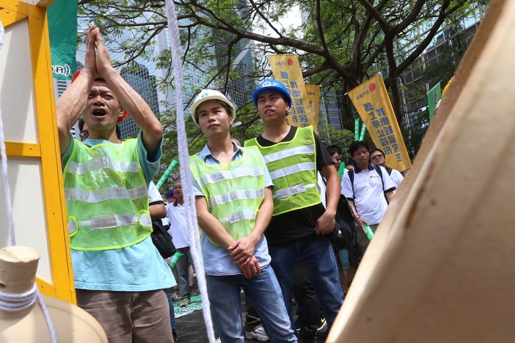 Construction workers march against Legco filibustering in a protest last year. Photo: K. Y. Cheng