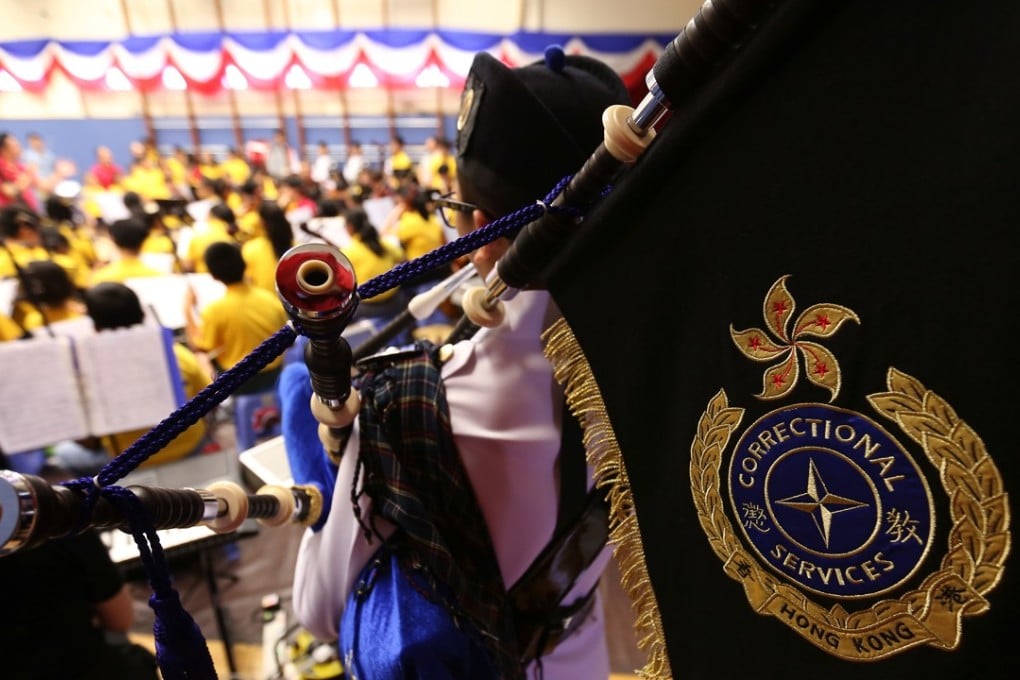 An inmate plays the bagpipes with orchestra members at a rehearsal in Stanley Prison. Photo: Xiaomei Chen