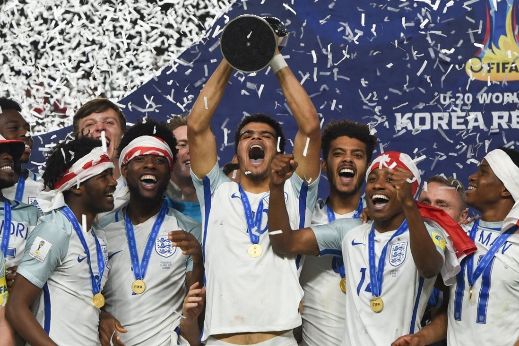 England players celebrate with the trophy during the awards ceremony after winning the U-20 World Cup final. Photo: AFP