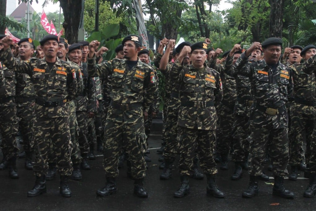 Members of the Banser Gerakan Pemuda Ansor, a paramilitary wing of Indonesia's biggest Muslim organisation Nahdatul Ulama (NU), during a roll call in Sidoarjo. Photo: AFP