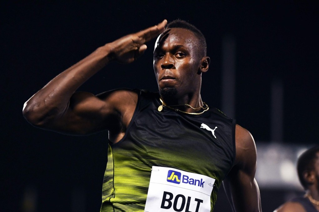 Usain Bolt salutes the crowd as he crosses the finish line of his final race in his home country. Photo: AFP