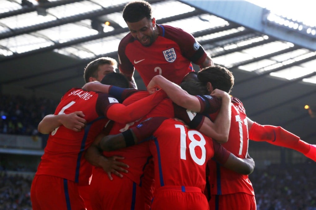 England’s Harry Kane is mobbed by teammates after netting a late equaliser. Photo: Reuters