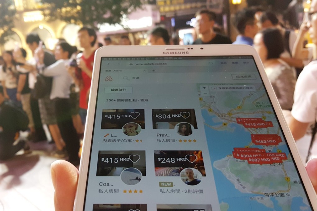A tourist is checking the Airbnb app with his mobile device in Causeway Bay. Photo: Martin Chan