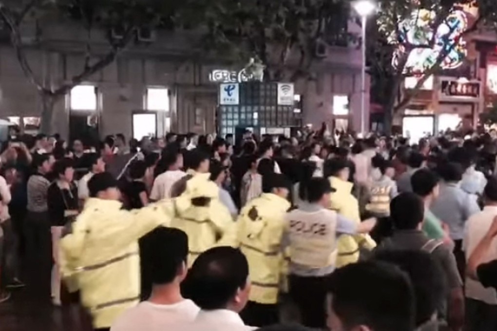 Hundreds of demonstrators marched through a shopping district in Shanghai on Sunday protesting against changes to housing regulations. SHKP has halted sales of converted apartments in the city. Photo: Handout