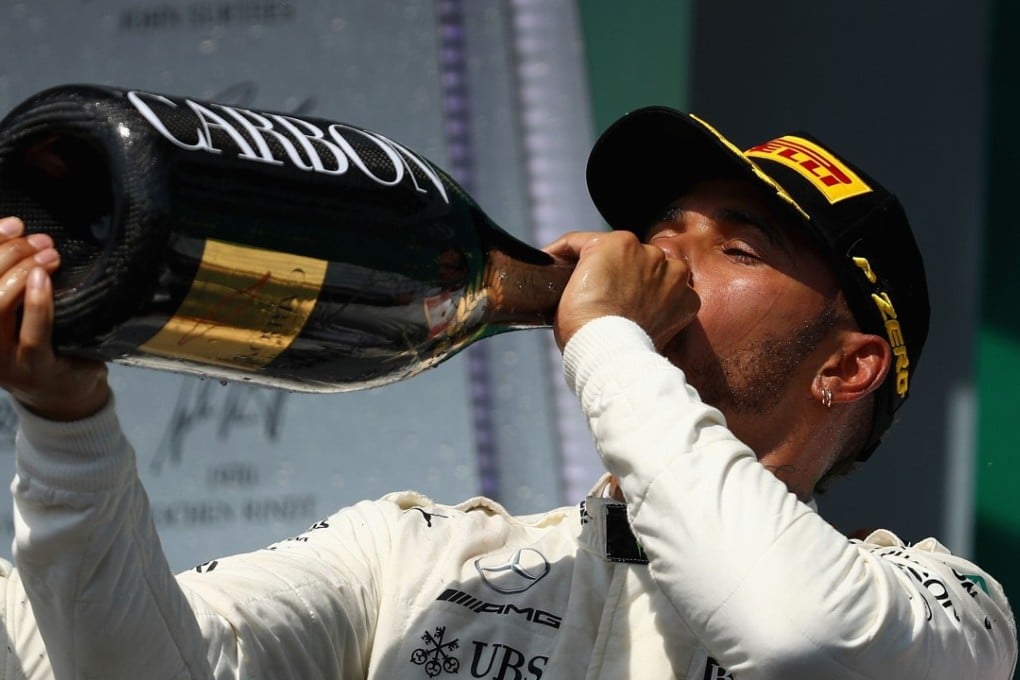 Race winner Lewis Hamilton of Mercedes drinks the winner’s champagne on the podium after the Canadian Formula One Grand Prix. Photo: AFP
