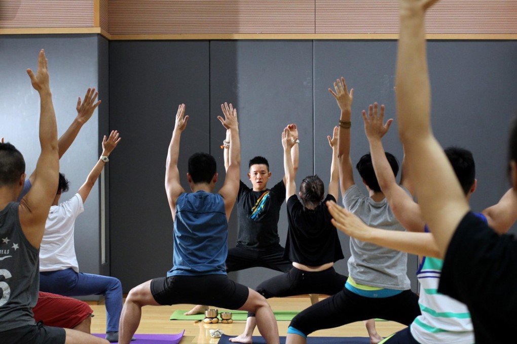 Yoga classes have income a routine for many Hong Kong residents and executives to fend off stress and stay healthy. Photo: Nora Tam
