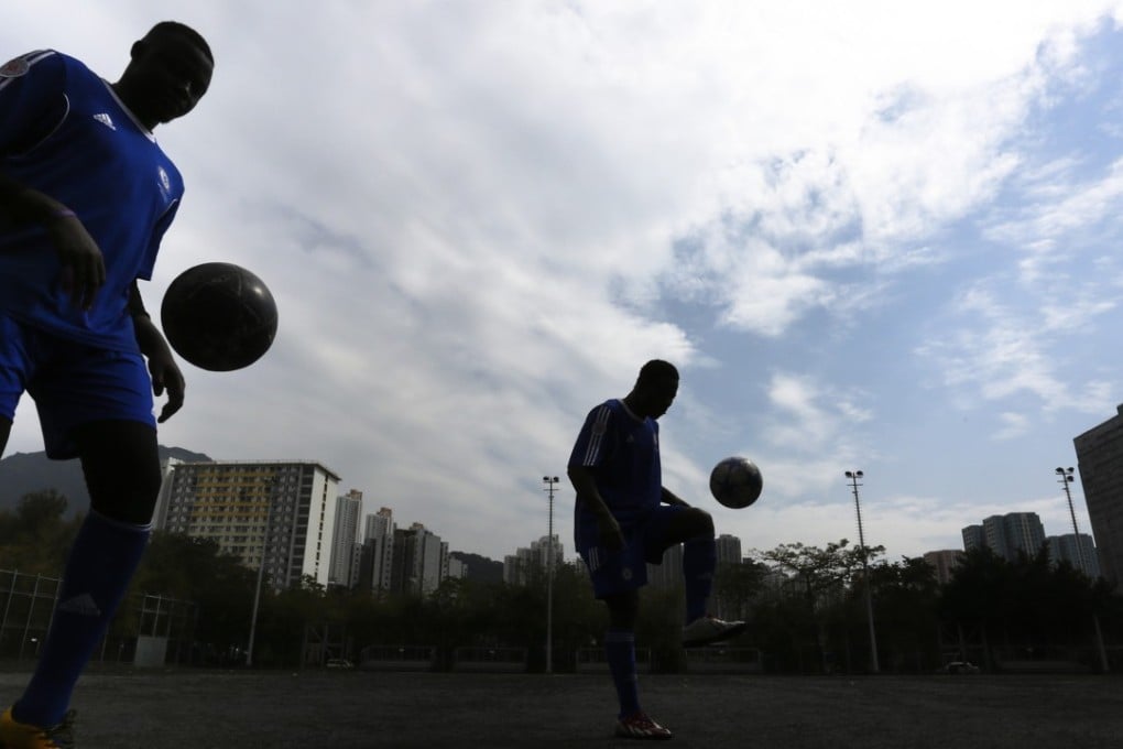Players from All Black FC, an all-African team made up entirely of refugees and asylum seekers with support from the Chelsea FC Soccer School, practise in Kowloon Bay Park. Photo: Jonathan Wong