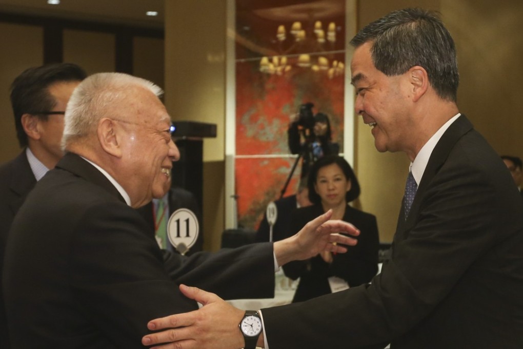 Former Hong Kong chief executive Tung Chee-hwa (left) shaking hands with incumbent chief executive Leung Chun-ying at the forum at the Conrad Hotel in Admiralty on Monday. Photo: K. Y. Cheng