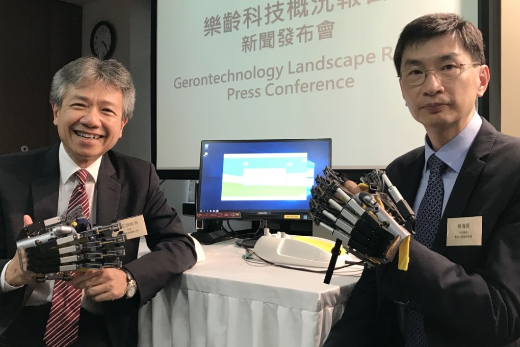 (From left) Professor Stephen Cheung Yan-leung, chairman of the Social Innovation and Entrepreneurship Development Fund Task Force, and Chua Hoi-wai, chief executive of the Hong Kong Council of Social Service, show off technological devices designed for the elderly. Photo: Elizabeth Cheung