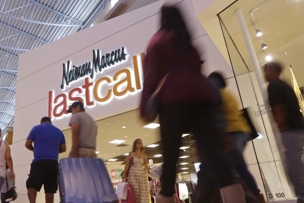 Shoppers walk by a Neiman Marcus Last Call department store in Miami. Neiman Marcus has given up hopes for a sale due to its enormous debt burder. Photo: AP