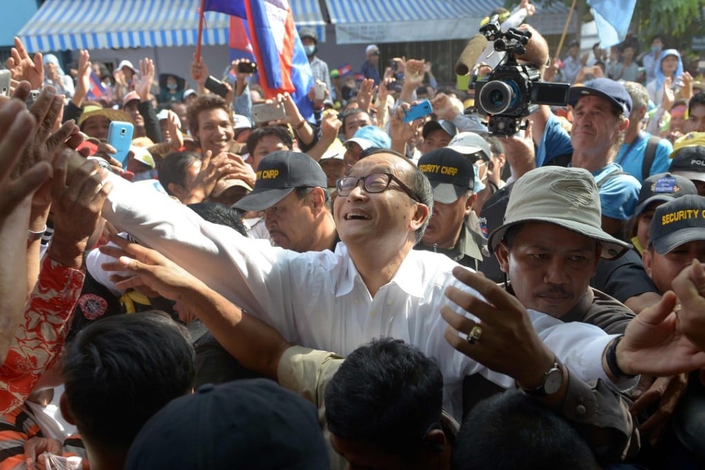 Sam Rainsy greets supporters during a demonstration in Phnom Penh in 2013. File photo: AFP