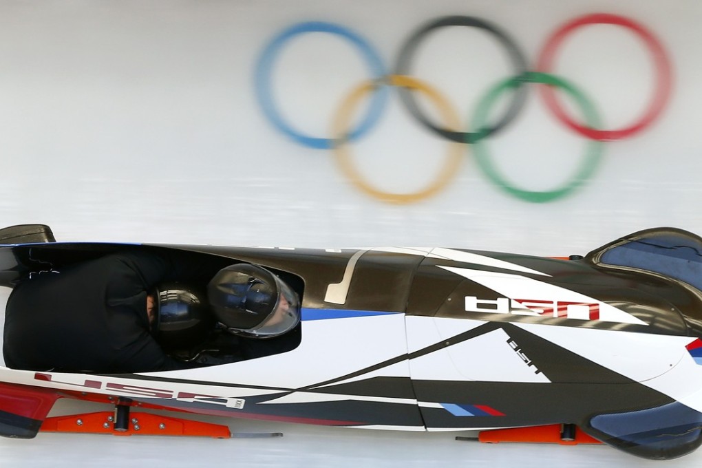 Steven Holcomb pilots a sled down the ice at training. Photo: Reuters