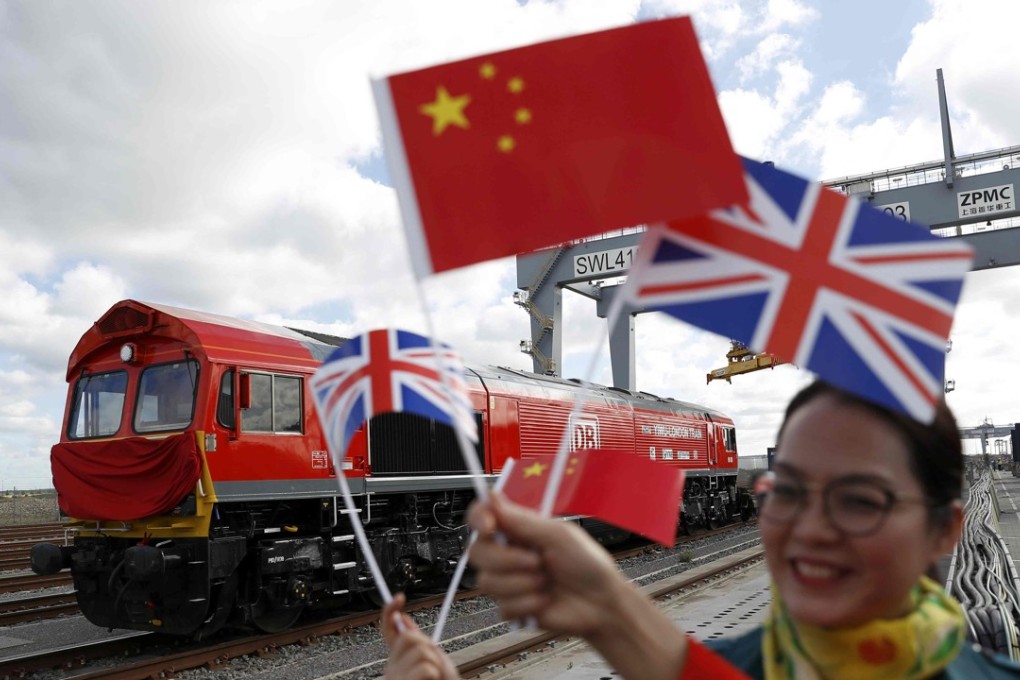 A Chinese woman waves flags at the official ceremony to mark the departure of the first UK to China export train, laden with containers of British goods, from the DP World London Gateway, Stanford-le-Hope, Britain in April. Photo: Reuters