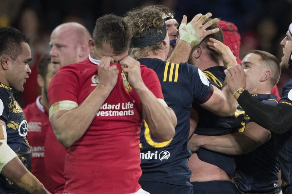 Lions captain Sam Warburton wipes his face as the Highlanders celebrate a try in their nail-biting victory in Dunedin. Photo: AP
