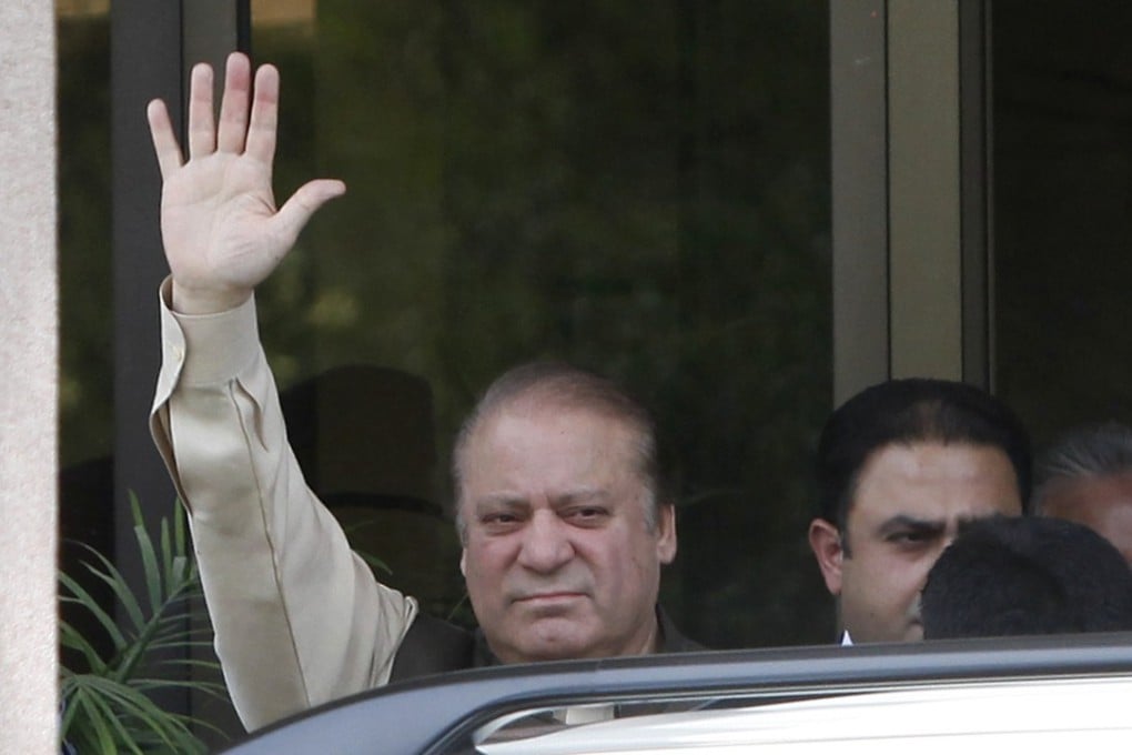 Pakistan’s Prime Minister Nawaz Sharif waves as he appears outside the Joint Investigation Team’s offices in Islamabad. Photo: AP