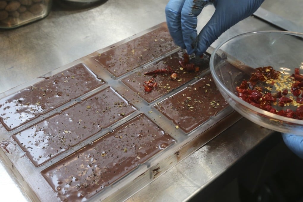 Chillies are added to freshly moulded chocolate bars at Hakawa Chocolate, in Central. Pictures: K.Y. Cheng