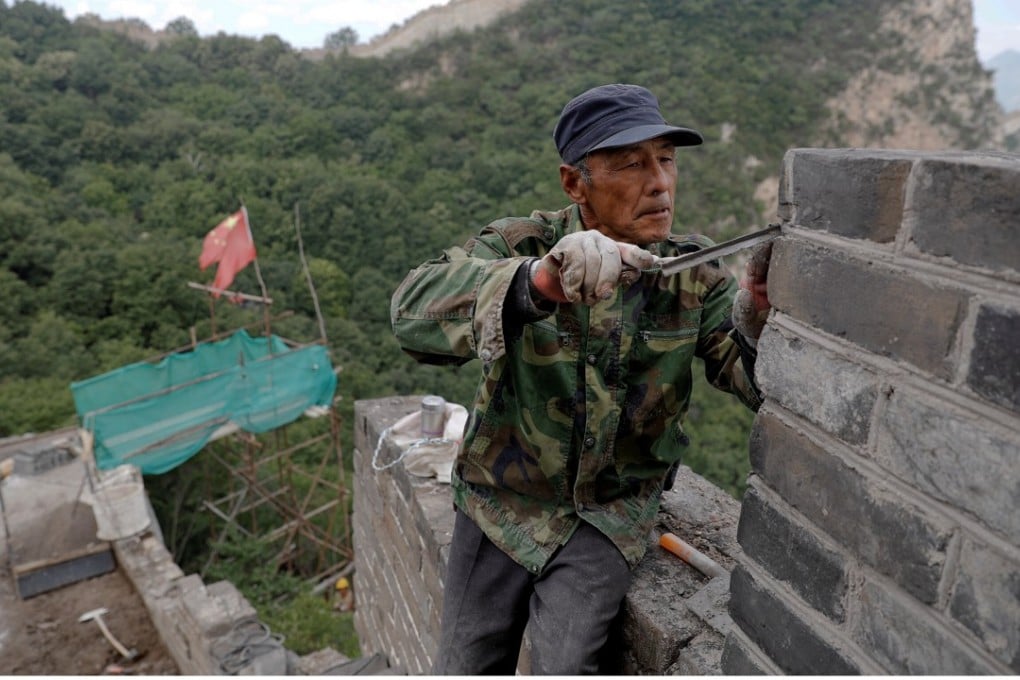 Men work on the reconstruction of the Jiankou section of the Great Wall of China, in Huairou District, north of Beijing. Photo: Reuters