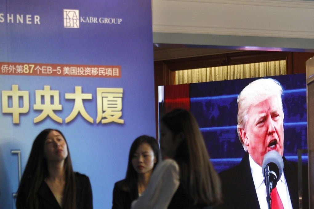 A projector screen shows a footage of US President Donald Trump as workers wait for investors at a reception desk during an event promoting EB-5 investment in a Kushner Companies development, at a hotel in Shanghai, China, on Sunday, May 7, 2017. The company is seeking Chinese investors for a project in New Jersey. Photo: AP