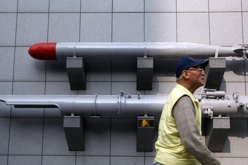 A man walks past a torpedo on display outside the Taiwan Armed Forces Museum in Taipei. Photo: Reuters