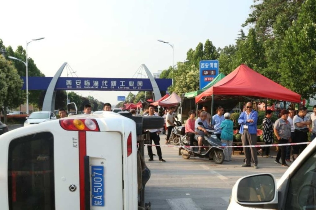 A government vehicle lies on its side after a fight broke out between street vendors and urban management officials in Xian, capital of Shaanxi provinc e. Photo: Handout