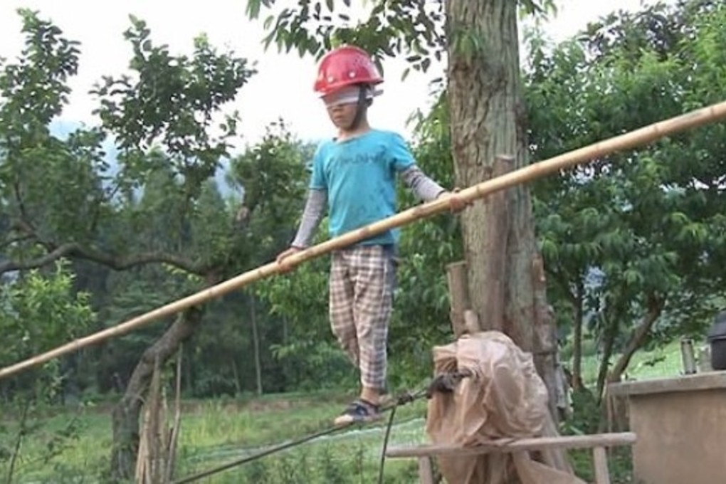 Six-year-old Wang Wang practises tightrope walking while blindfolded. Photo: Handout