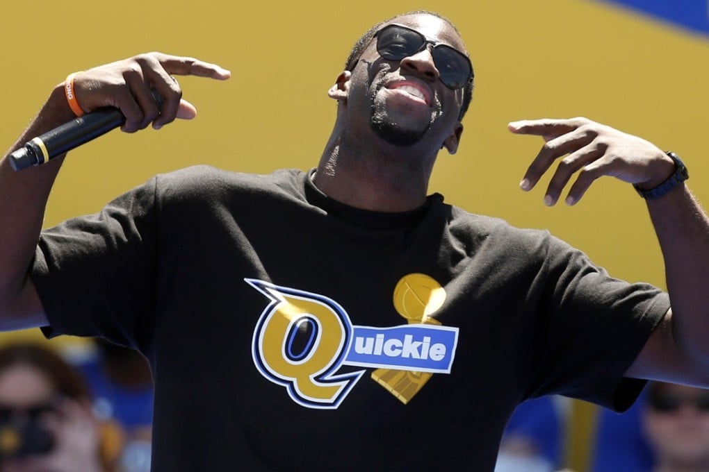 Draymond Green revels in his T-shirt mocking the Cavaliers as he speaks to the crowd at the Golden State Warriors’ NBA championship rally at Lake Merritt. Photo: TNS