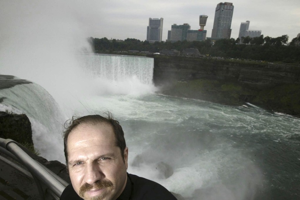 FILE- In this Aug. 13, 2004, file photo, Kirk Jones poses for a photo at Terrapin Point on the American side of Horseshoe Falls in Niagara Falls State Park, N.Y. Jones, who survived a plunge over Niagara Falls without protection in 2003 has died after he went over again, this time inside an inflatable ball. Police told the Syracuse Post-Standard that the body of the 53-year-old was found in the Niagara River by the U.S. Coast Guard on June 2, 2017. (Chip Somodevilla/Detroit Free Press via AP, File)