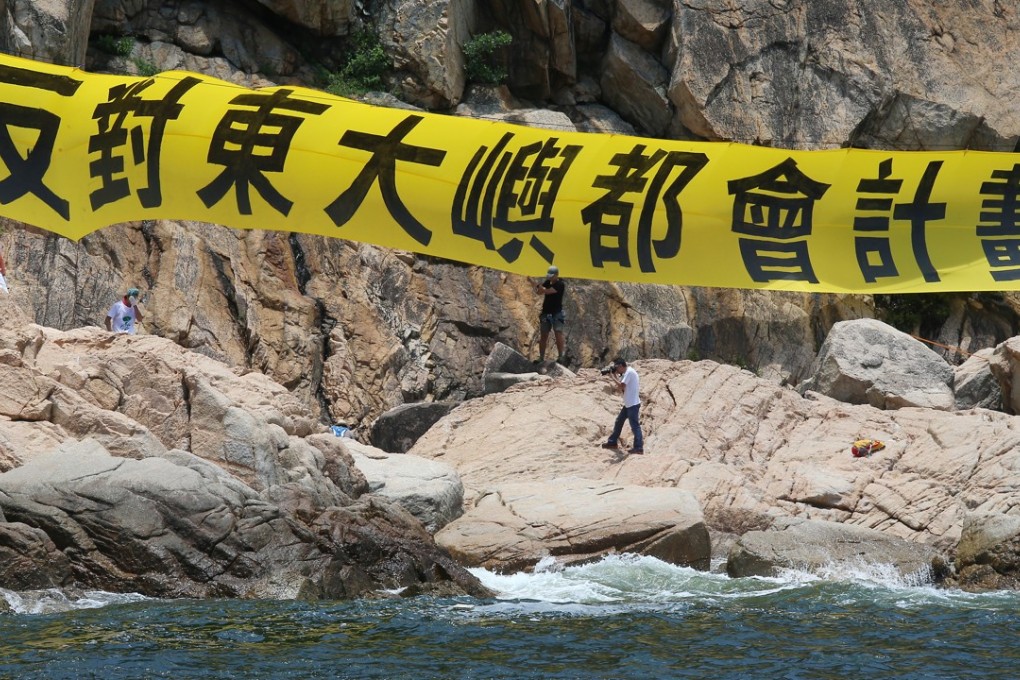 A member of the Save Lantau Alliance protests against plans for a new metropolis off southeast Lantau. Photo: K. Y. Cheng
