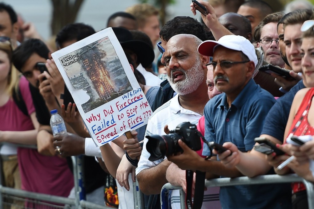 Angry locals question London Metropolitan Police Commander Stuart Cundy during a police statement close to Grenfell Tower. Photo: EPA