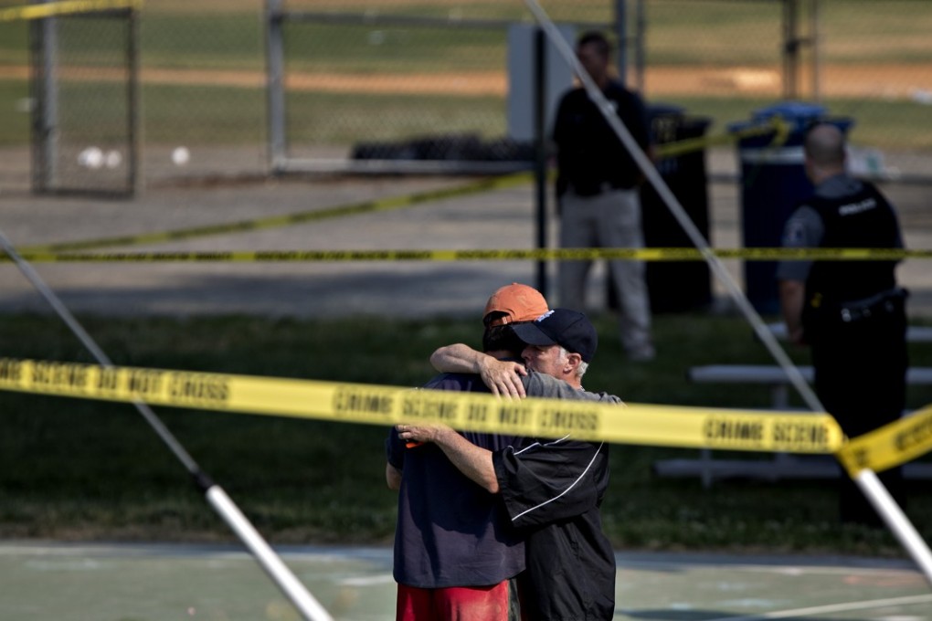 Two people hug in front of police crime scene tape following the shootings during a congressional baseball practice at the Eugene Simpson Stadium Park in Alexandria, Virginia, on June 14. Photo: Bloomberg