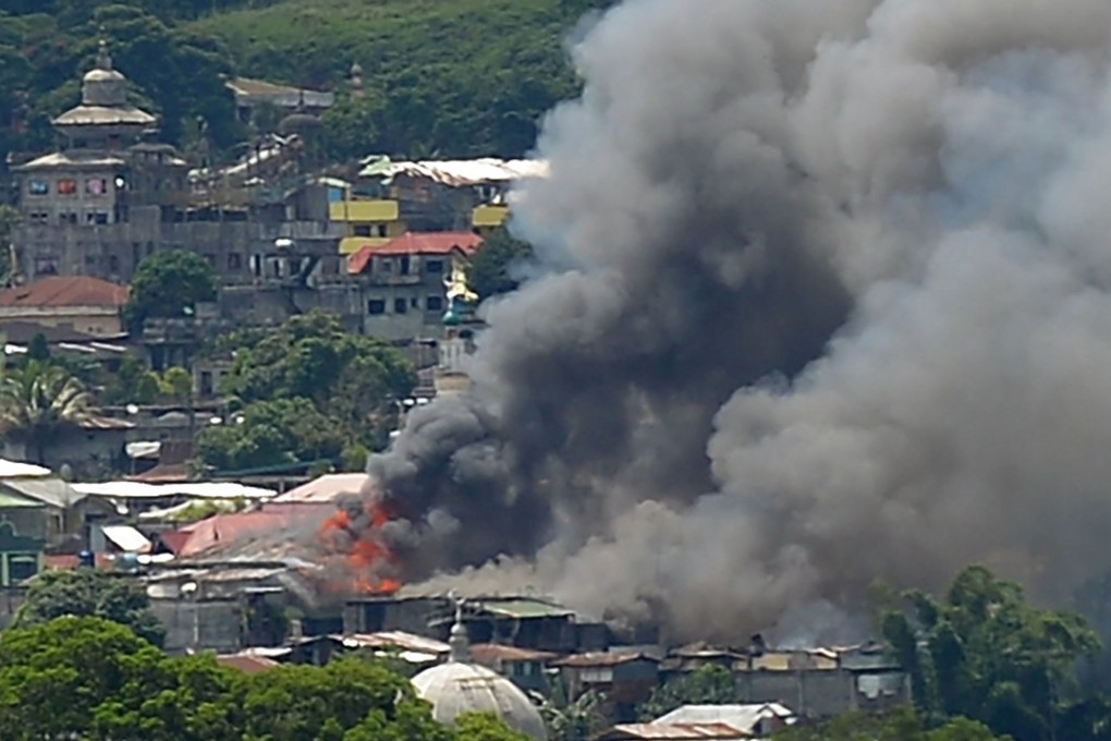 Smoke billows from burning buildings in Marawi on Mindanao on Sunday. Photo: AFP