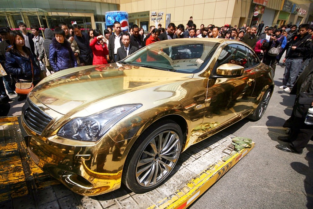 A file picture of a gold sports car pictured in a busy shopping area in Nanjing. Photo: China Foto Press