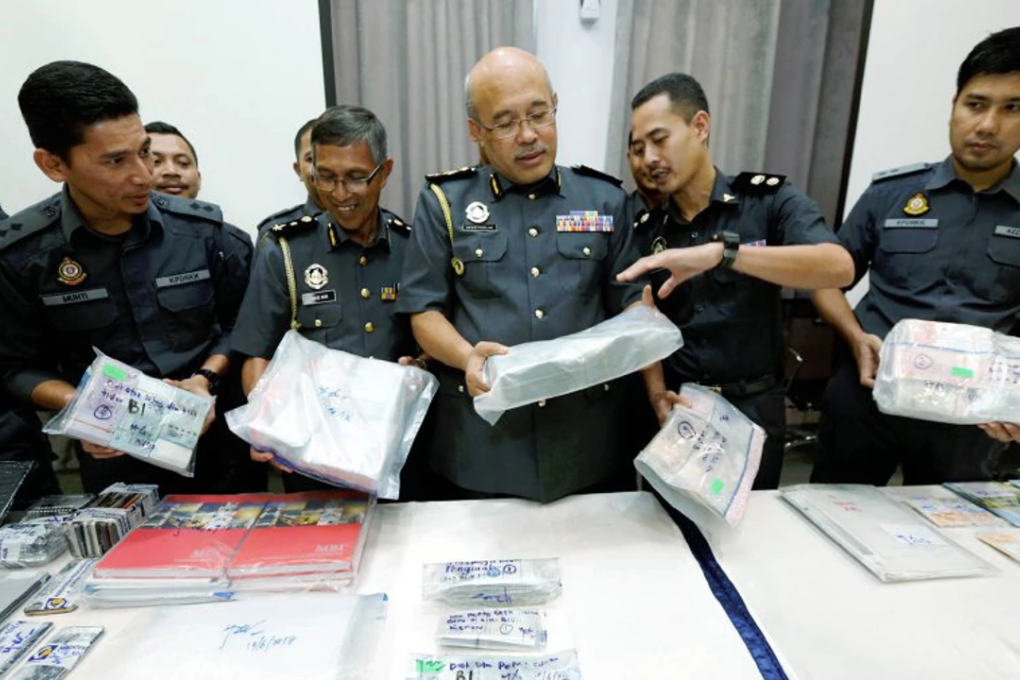 Domestic Trade, Cooperatives and Consumerism Ministry (KPDNKK) enforcement division director Datuk Mohd Roslan Mahayudin with the seized items. Photo: Ramdzan Masiam/New Straits Times