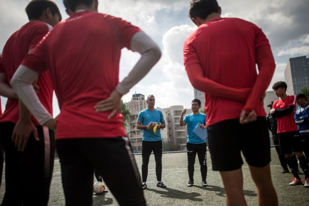Beijing Institute of Technology’s Spanish head coach Roberto Ahufinger del Pino (centre) talks during a training session. Photo: AFP