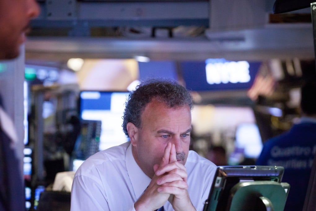A trader warily eyes stock movements in the New York Stock Exchange (NYSE). Index provider MSCI added China A-shares in its global index after trading ended for the session. Photo: Bloomberg