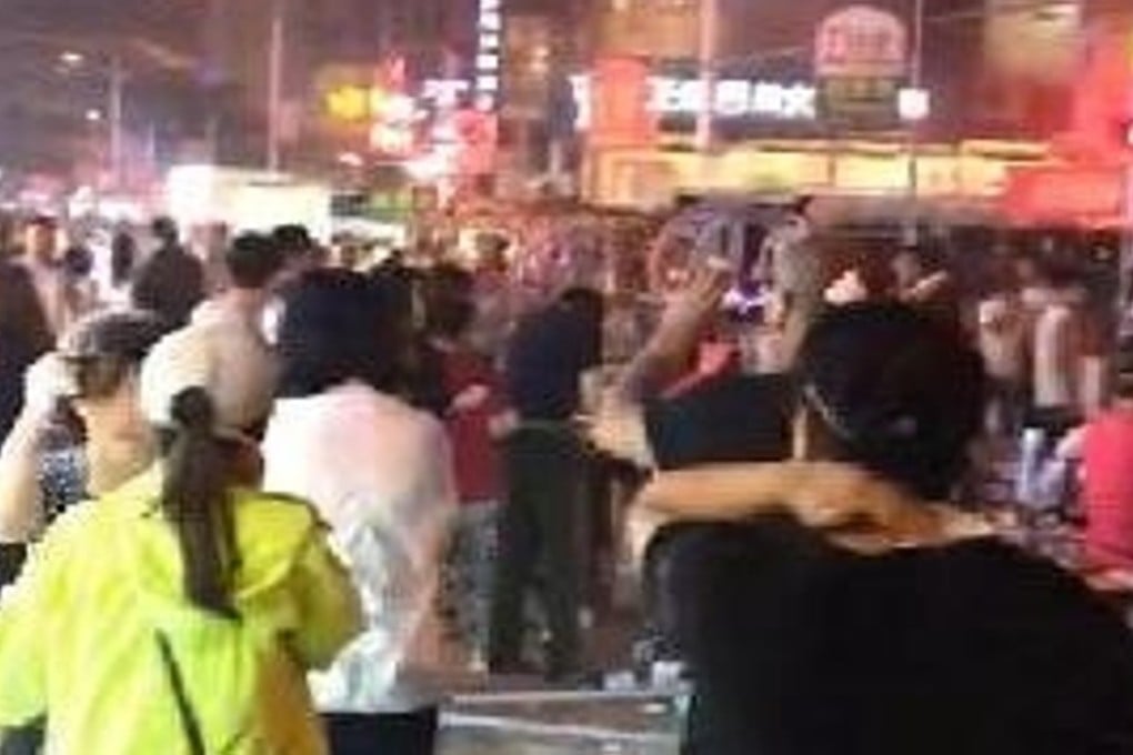 Crowds gather in the street after a blast at a pancake shop tore through a local market Photo: Handout