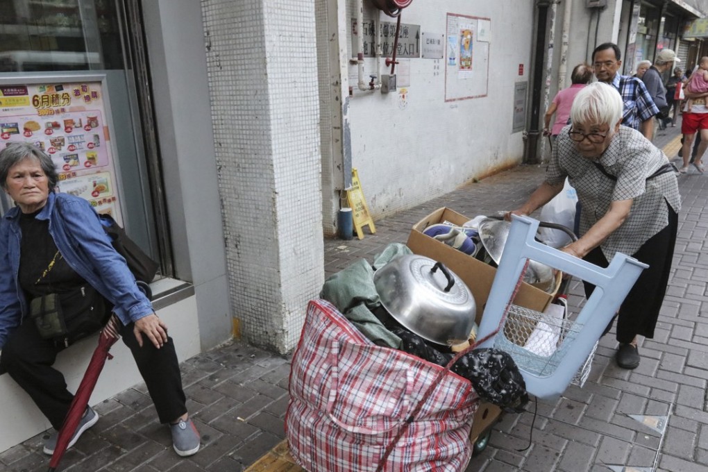 Hong Kong is a city where old women sell cardboard to make ends meet while businessmen pay millions for a place to park their fancy cars. Photo: Felix Wong